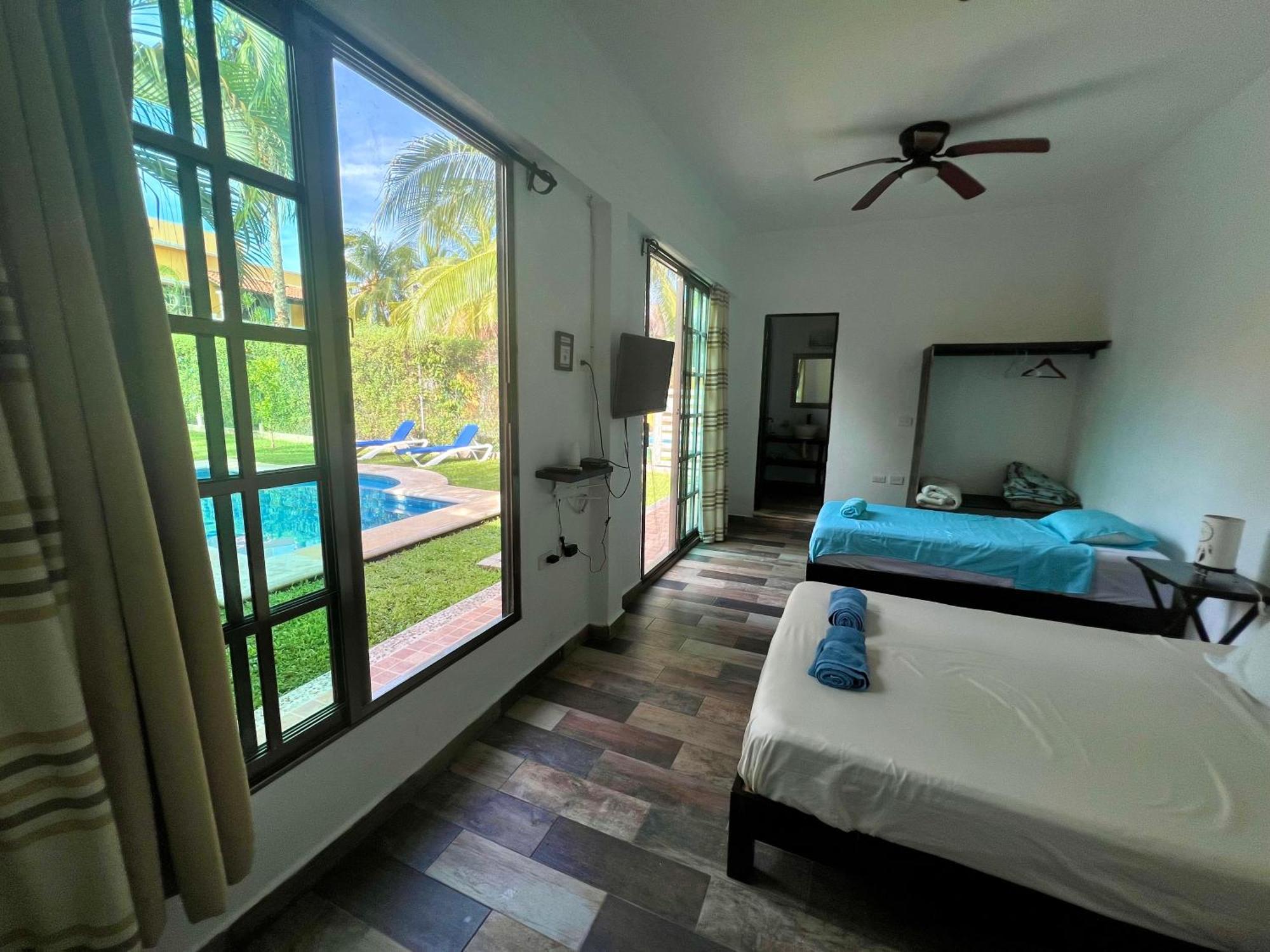 Quadruple Room with Balcony and view to the garden and pool